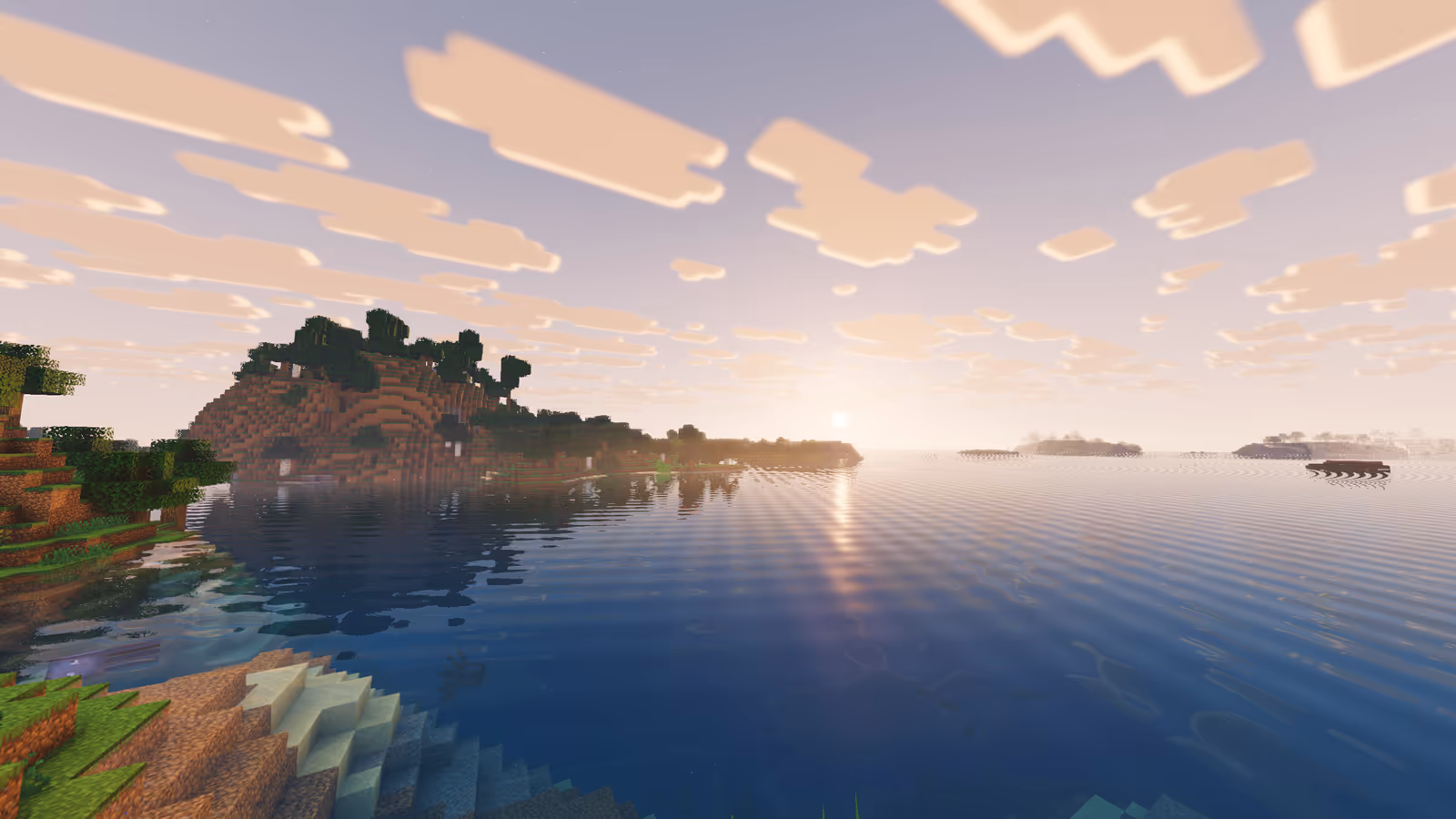 Sunset reflected in a lake beside a forested island
